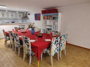 a dining room with a red table and chairs at Villa Coronille calme et nature in Entrecasteaux