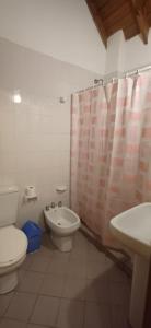 a bathroom with a toilet and a bidet and a sink at Duplex 7 Lunas in Villa Gesell
