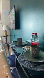 a glass table with two bottles of water on it at Amazing Beach View Studio Unit - Walking Distance to US Embassy & St Lukes Ermita in Manila +14 photos