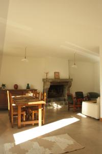 a living room with a table and a fireplace at Le Carrouge, jolie maison cancalaise in Cancale +14 photos