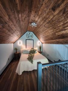 a bedroom with a large bed with a wooden ceiling at Life's Good Friends Retreat in Brevard