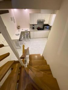 a view of a kitchen with a stairway to a room at Casa Centro Histórico Cuenca in Cuenca