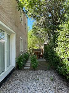 a house with a patio and a table next to a building at Duplex Las Margaritas Bosque Peralta Ramos in Mar del Plata