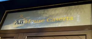 a sign for a house caserta on top of a door at AB House Caserta - Reggia di Caserta e Stazione Fs a cinque minuti in auto in Caserta