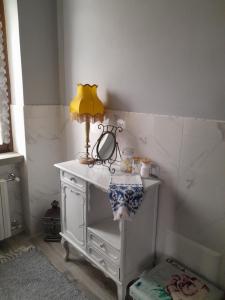 a white table with a lamp on top of it at PALAZZO Bed and Breakfast in Calvisano