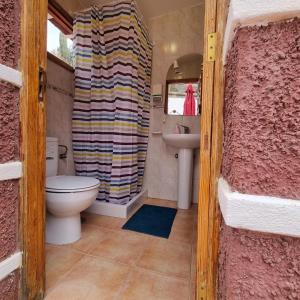 a bathroom with a toilet and a sink at Villa Margarita in Santa Lucía +81 photos