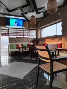 a restaurant with tables and chairs and a flat screen tv at Hotel Chachapoyas in Chachapoyas