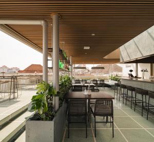 a restaurant with tables and chairs on a patio at Maison Wilhelmina in Bandung