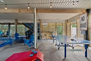 a room with two ping pong tables and a staircase at Panferio SeaCret in Pensacola Beach