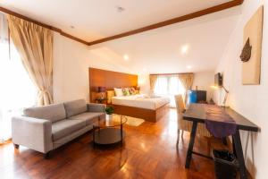 una sala de estar con un sofá y una cama en Mak Sukhumvit 15, en Bangkok