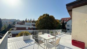 Un patio con una mesa y sillas en un balcón. en Luxury Penthouse on Rosehill with free garage -240sqm, en Budapest