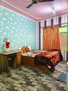 a bedroom with a bed and a desk with a desk at Luminaire Homestay in Srinagar