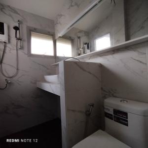 a bathroom with a toilet and a sink at CHILLI's Villa1 in Chiang Mai