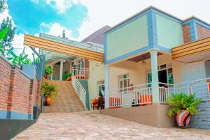 a house with a staircase in front of it at CLEMENT MOTEL in Rutsiro