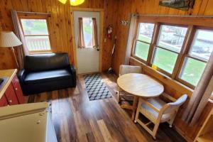 a small living room with a table and a chair at Marina View 1 Bedroom Sunset Cabin in Kabetogama