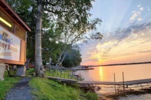 a sign for a dry bear seafood restaurant next to a lake at Marina View 1 Bedroom Sunset Cabin in Kabetogama