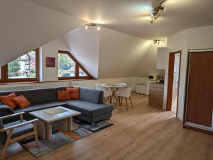 a living room with a couch and a table at Apartmany u Denyho in Zuberec