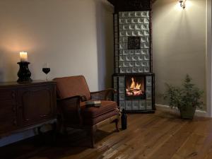 a living room with a chair and a fireplace at Tervey-villa in Révfülöp