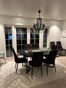 a dining room with a black table and chairs at Sigerfjordveien 501 in Sortland