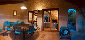a dining room with a table and blue chairs at Grande Villa, Corse du Sud, Domaine privé de Cala Rossa in Porto-Vecchio