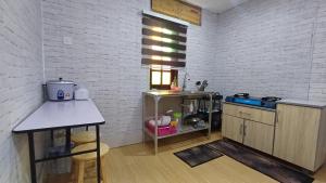 a kitchen with a sink and a counter in a room at HOMESTAY ANAK SYURGA AMzAR MALAY ONLY in Kangar