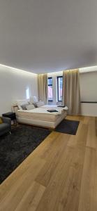 a bedroom with a large bed in a room with wooden floors at Room16-Ulm in Ulm