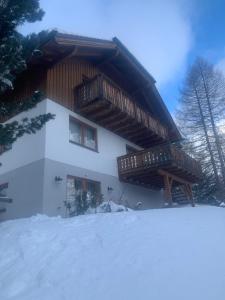 a building with snow in front of it at Ferienhaus Vier Jahreszeiten in Reichenau