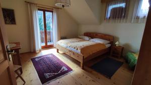 a bedroom with a bed and a large window at Ferienhaus Vier Jahreszeiten in Reichenau