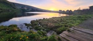 a view of a river with the sunset in the background at Ferienhaus Vier Jahreszeiten in Reichenau +11 photos
