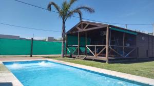 a house with a pool in front of it at Don Gregorio in Empalme Lobos