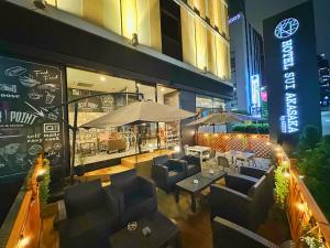 a restaurant with couches and tables in front of a building at HOTEL SUI AKASAKA by ABEST in Tokyo