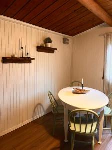 a dining room with a table and chairs at Stuga 1 in Arvidsjaur