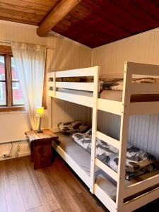 a bedroom with two bunk beds and a table at Stuga 1 in Arvidsjaur
