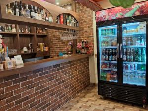 a drink refrigerator in a brick wall at Chandrama Hotel and Restaurant in Sauraha