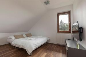 Postel nebo postele na pokoji v ubytování LOGAR Apartments