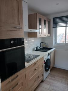 a kitchen with a sink and a stove top oven at Studio de plage in Sète