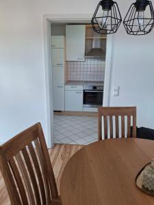 a kitchen and dining room with a table and chairs at Schöne Wohnung mit Balkon in Stockach