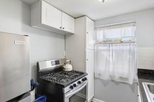 a small kitchen with a stove and a refrigerator at Heights Dream Libby Unit 6 in Maple Heights +3 photos