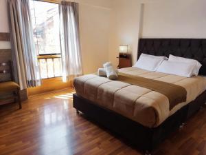 A bed or beds in a room at Anata Hotel