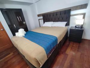 A bed or beds in a room at Anata Hotel