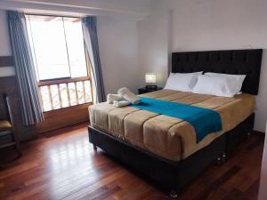 A bed or beds in a room at Anata Hotel