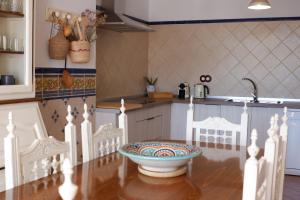 a kitchen with a bowl on a wooden table at Casa Frasquita del Pan - Caminito del Rey in Valle de Abdalagís +52 photos