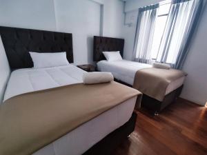 A bed or beds in a room at Anata Hotel