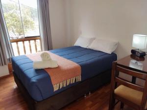 A bed or beds in a room at Anata Hotel