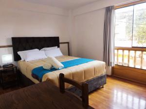 A bed or beds in a room at Anata Hotel