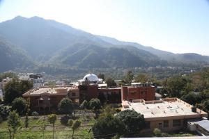 una vista di un edificio con le montagne sullo sfondo di Hotel yog tapovan MOUNTAIN VIEW ROOM a Rishikesh