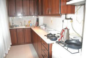 a kitchen with wooden cabinets and a counter top at Huzur 3 in Edirne