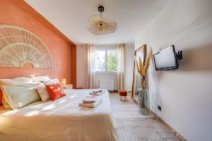 a bedroom with a large bed and a flat screen tv at Fridhome Parking Wifi Fibre 2MIN Tram in Bruges