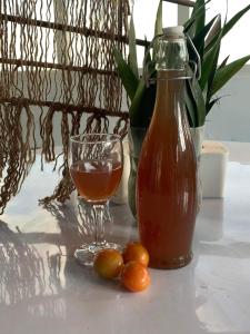 a drink and a glass of juice and some olives on a table at sanjivani buti organic krisi farm & resort in Nagarkot