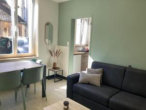 a living room with a couch and a table at Appartement centre bourg Toucy in Toucy
